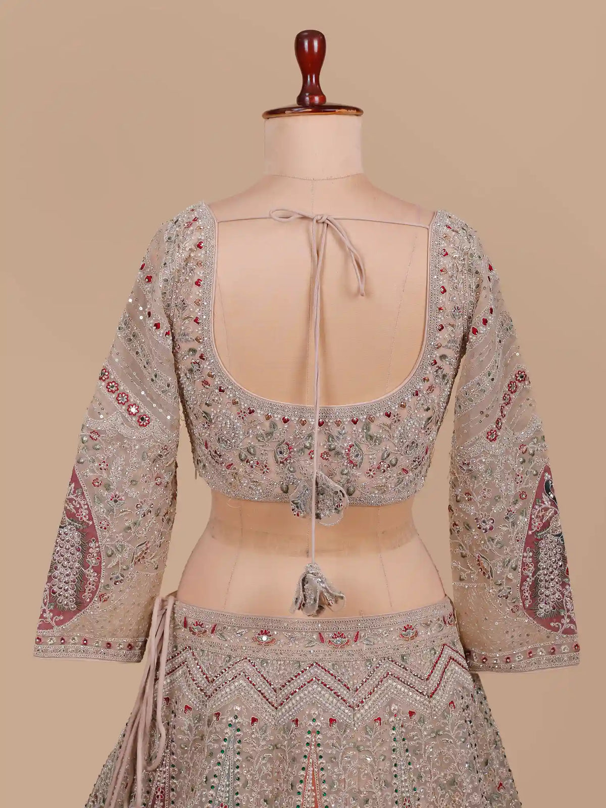 Pastel Champagne Lehenga Featuring Peacock Panels and Multicolor  Embroidery