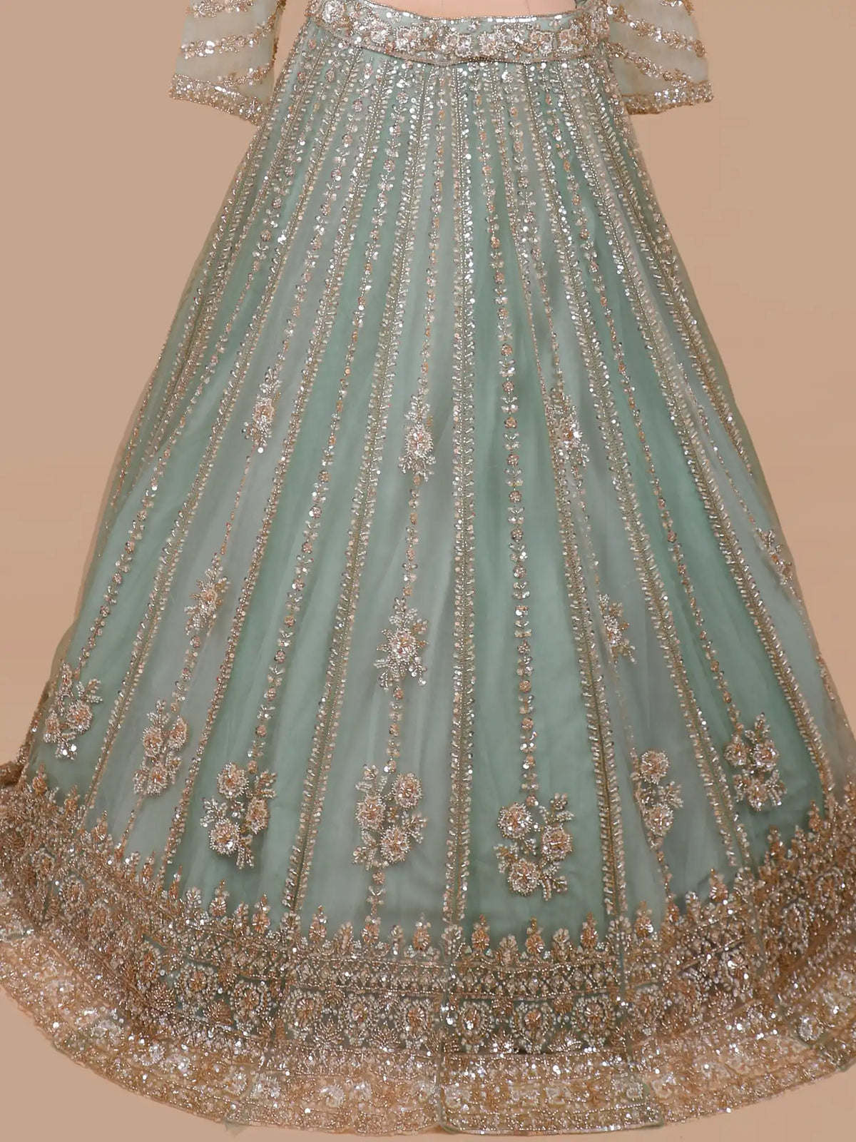 Pista Green Designer Net Lehenga Featuring Silver Gold Floral Embellishments