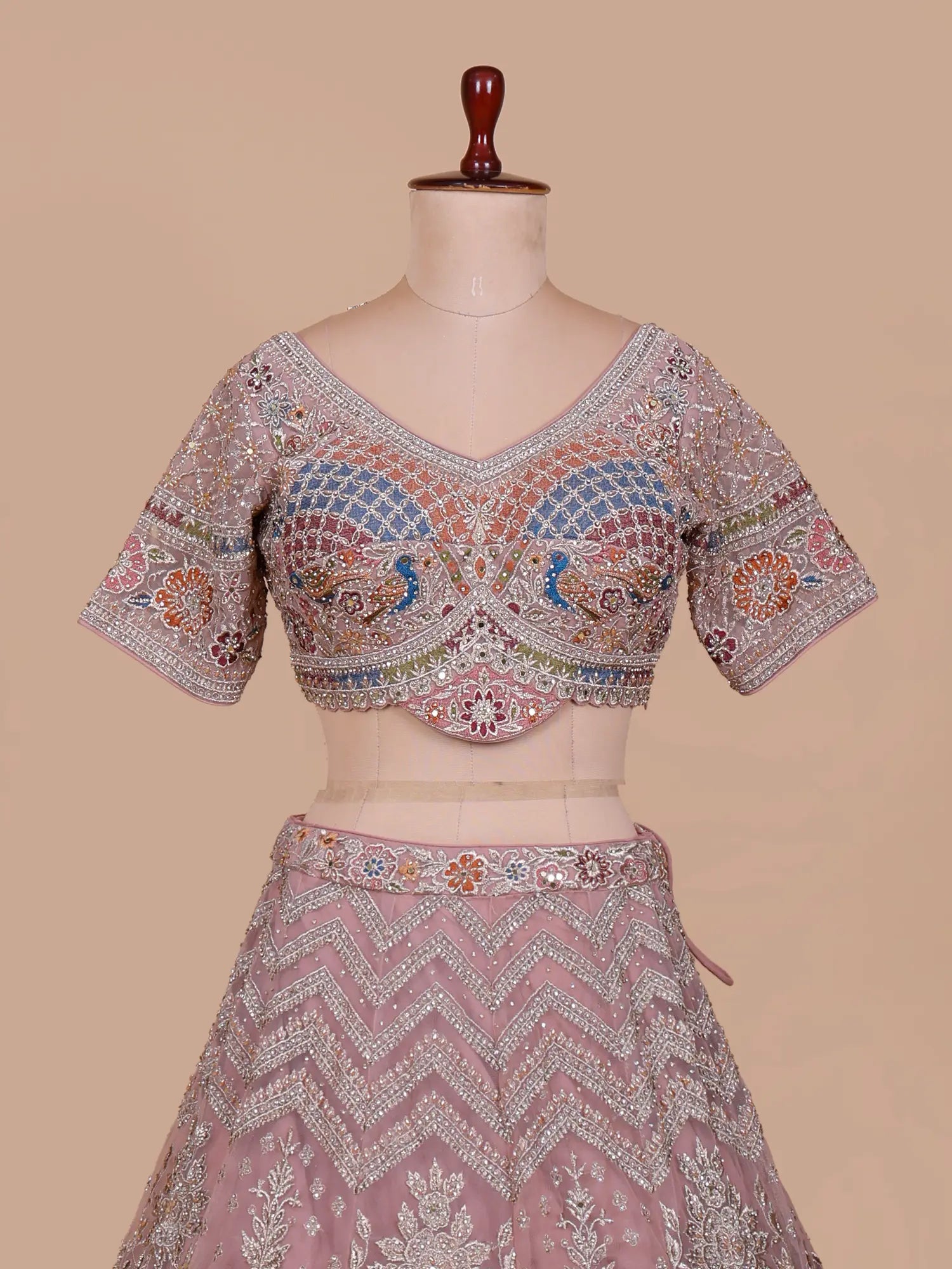 Discover Onion Pink Premium Lehenga Showcasing Artistic Bridal Figure Embroidery