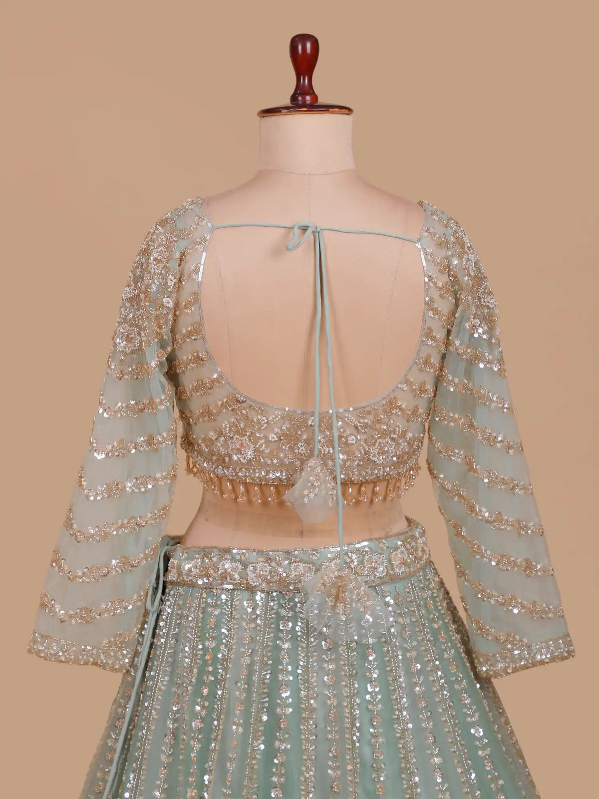 Pista Green Designer Net Lehenga Featuring Silver Gold Floral Embellishments