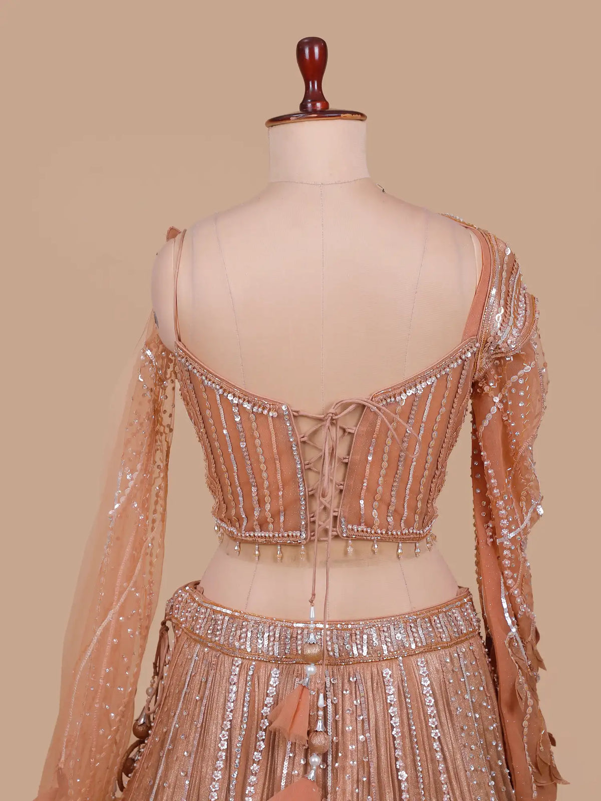 Antique Peach Designer Net Lehenga with Single Sheer Sleeve and Draped  Cape
