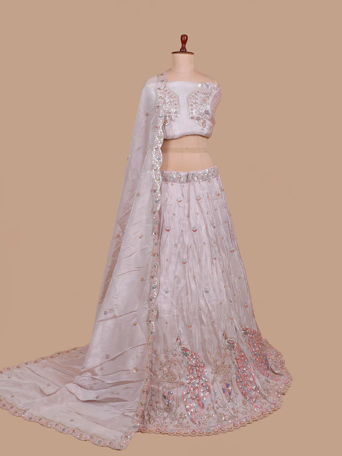 Pastel Pink Shimmer Organza Lehenga Showcasing Peacock Artistry