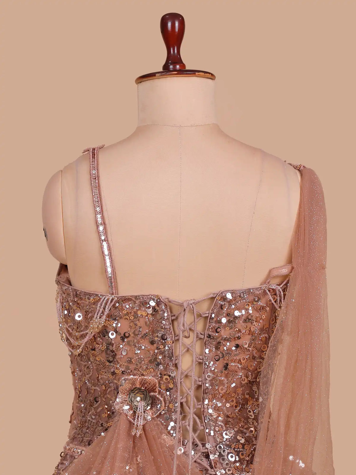 Peach Net Fishcut Lehenga Showcasing Sequin Beadwork and Corset Styling