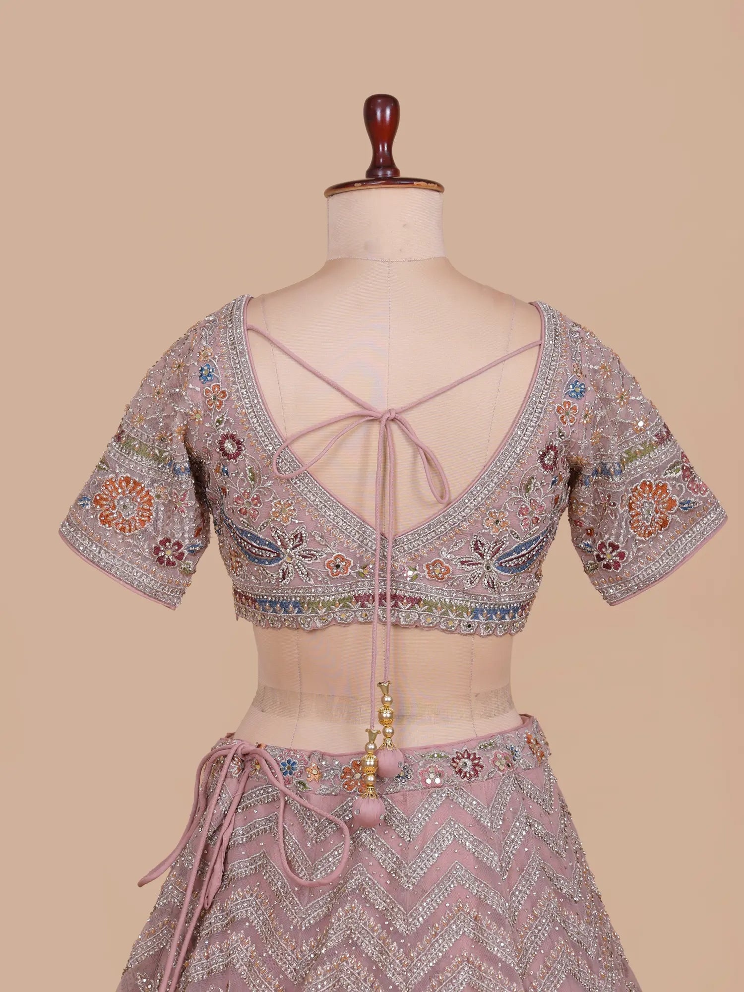 Discover Onion Pink Premium Lehenga Showcasing Artistic Bridal Figure Embroidery
